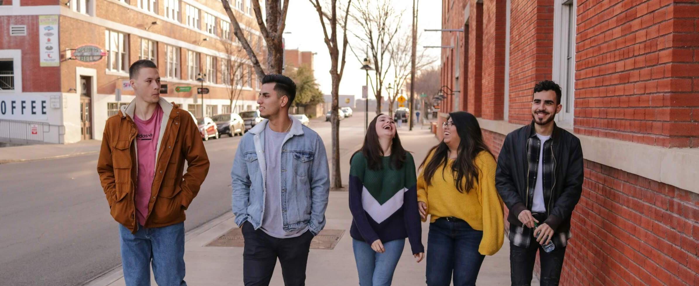 Young people walking and laughing on a street