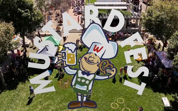 Aerial view of MustardFEST 2024 showing large decorative letters and festival attendees